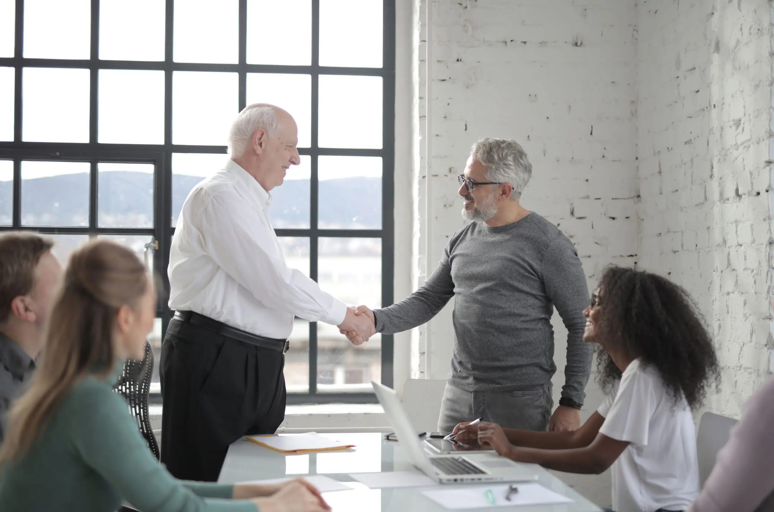 Business colleagues shaking hands during meeting