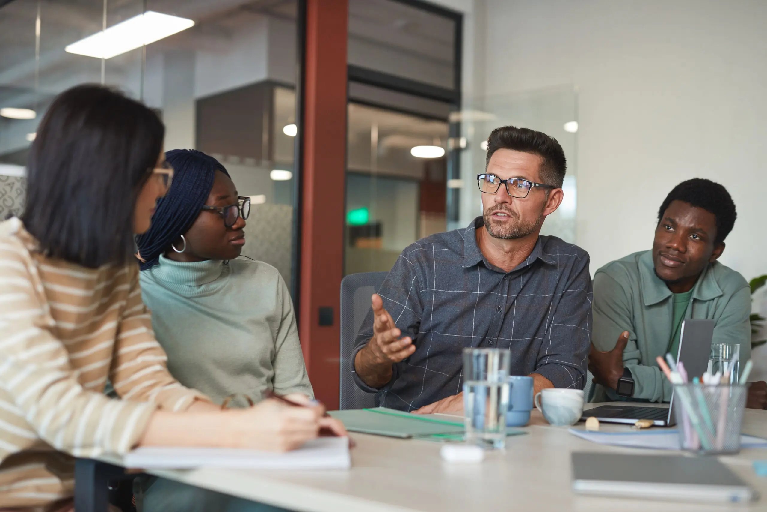 Group engaged in discussion around a table.